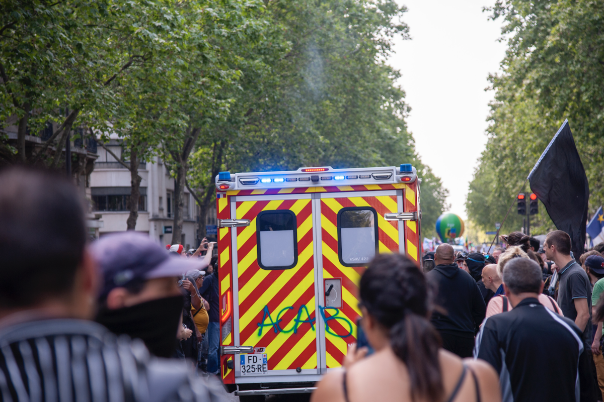 Un camion de pompiers remonte la manifestation et en profite pour faire passer un message. - © Reflets