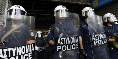 Greek police officers stand guard outside the finance ministry in Athens