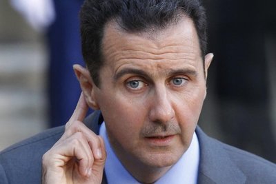 Syria's President Bashar al-Assad answers journalists after a meeting at the Elysee Palace in Paris
